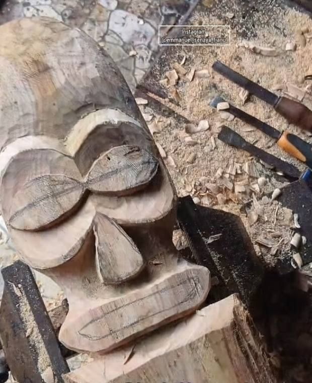 A mask roughed out in raw wood